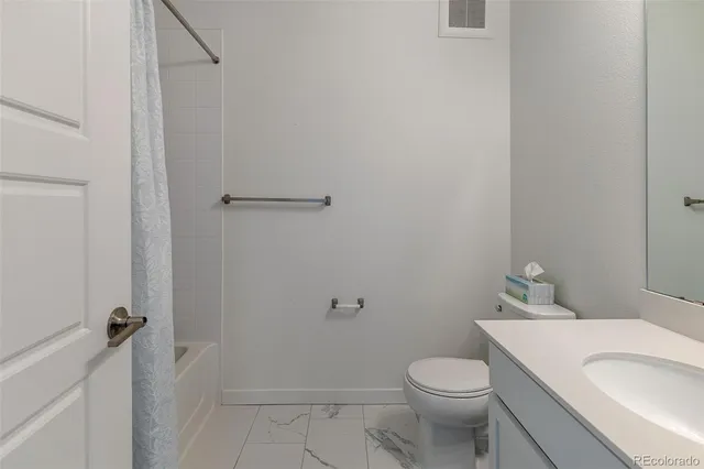 a white toilet sitting next to a bathroom sink