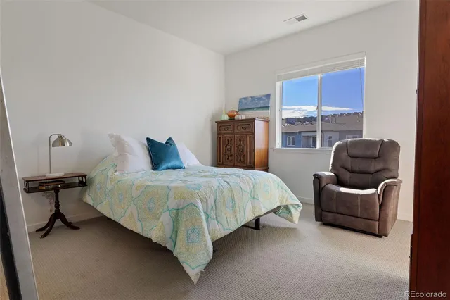 a bedroom with bed and chair