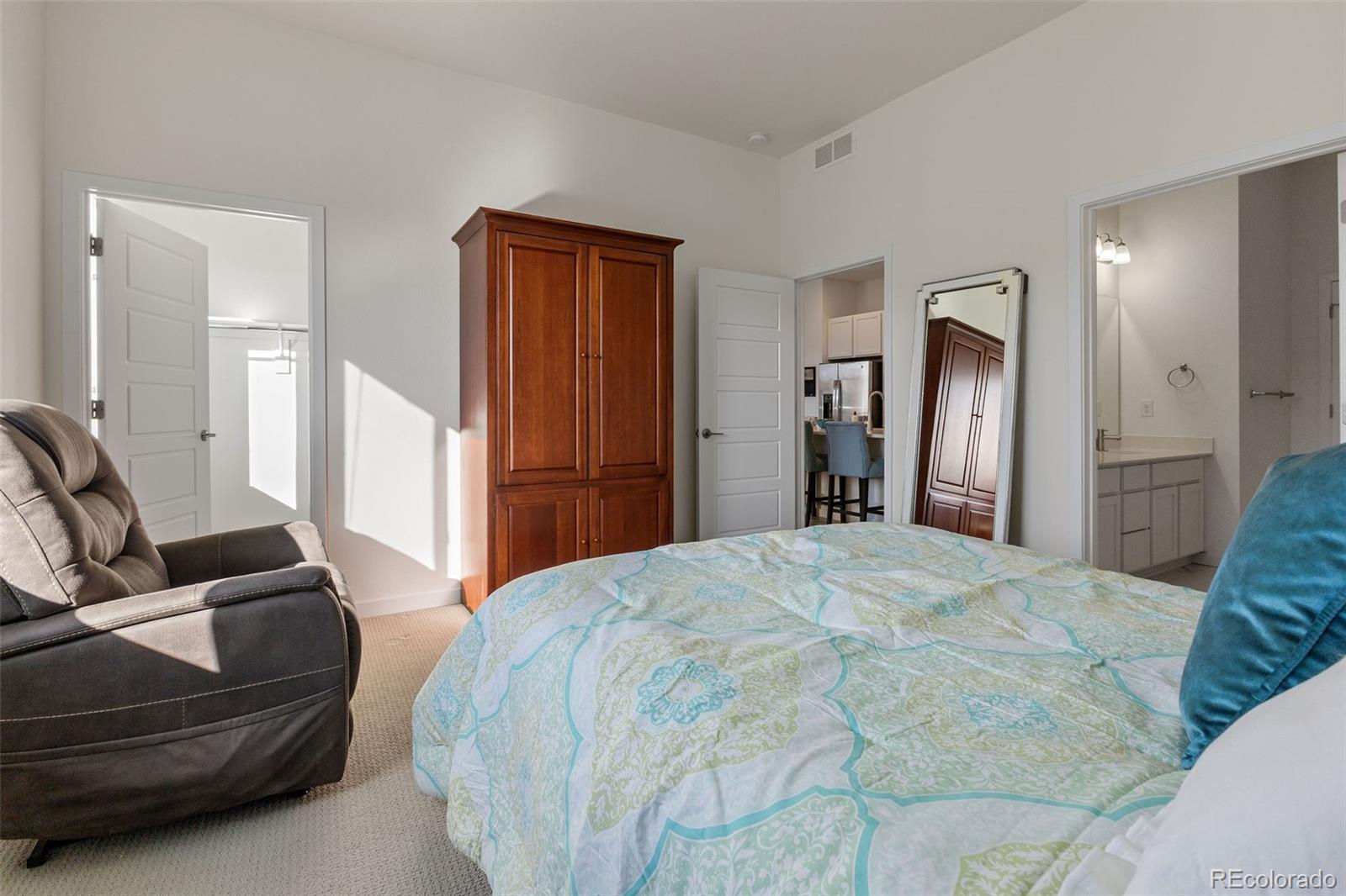 9287 Twenty Mile Road, Unit 401 Parker, CO 80134 - Photo 19 of 44 a bedroom with a bed and closet