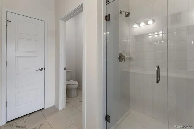 a bathroom that has a glass shower door