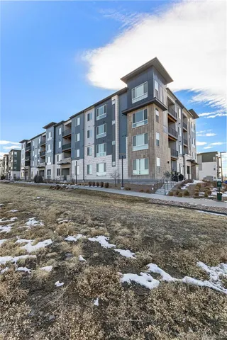 a living room with furniture and wall paintings