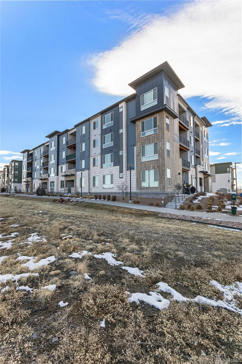 9287 Twenty Mile Road, Unit 401 Parker, CO 80134 - Photo 30 of 44 a view of a big house with a yard
