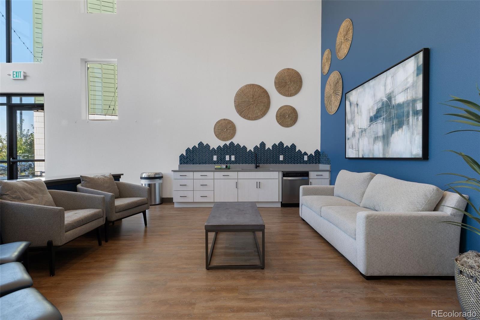 9287 Twenty Mile Road, Unit 401 Parker, CO 80134 - Photo 31 of 44 a living room with furniture and wall paintings