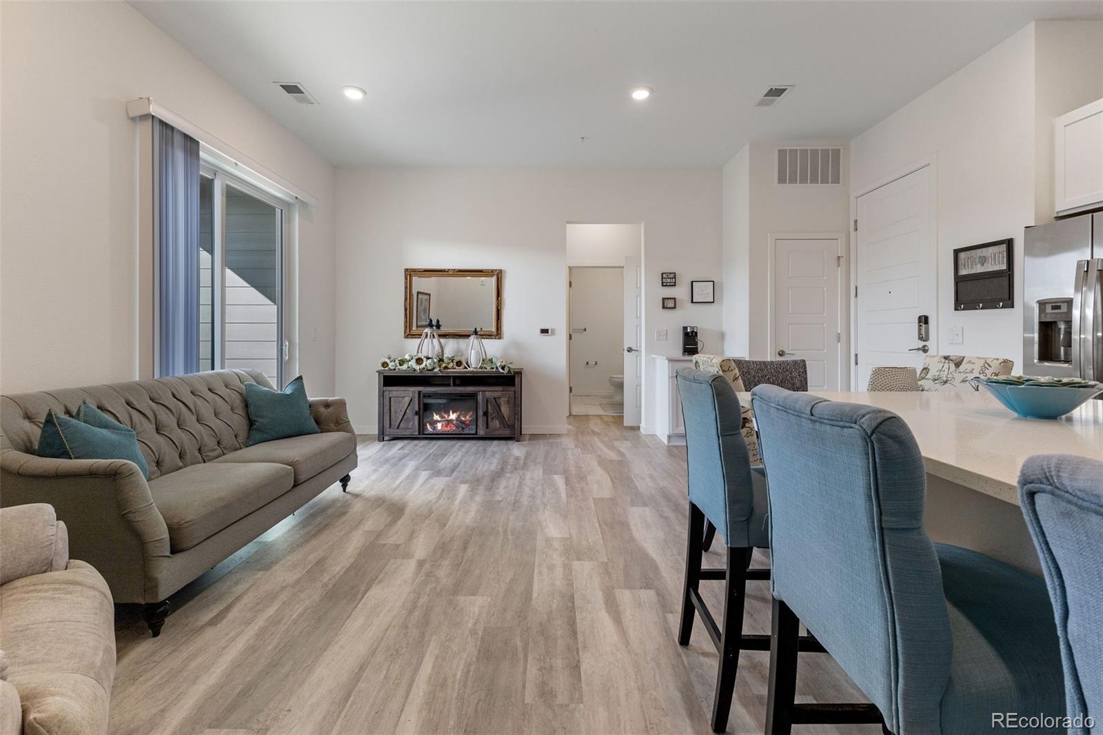 9287 Twenty Mile Road, Unit 401 Parker, CO 80134 - Photo 5 of 44 a living room with furniture and a wooden floor