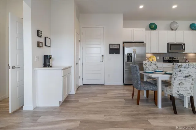 a kitchen with stainless steel appliances kitchen island granite countertop a refrigerator and a stove top oven