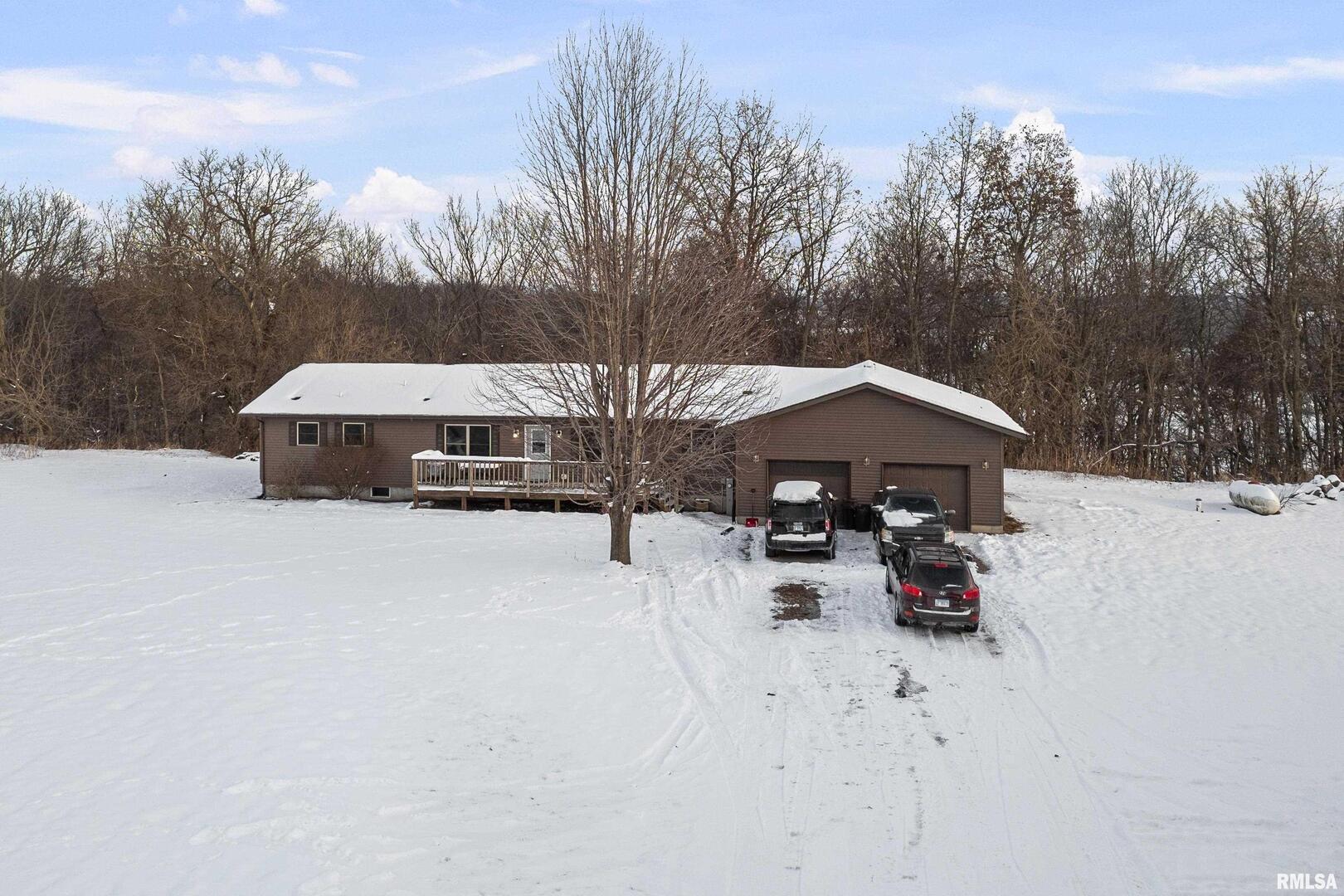 1231 90th Street Joy, IL 61260 - Photo 1 of 38 a view of a roof covered with snow in the background