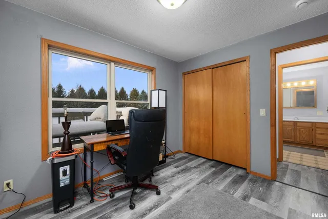 a bed sitting in a bedroom next to a window