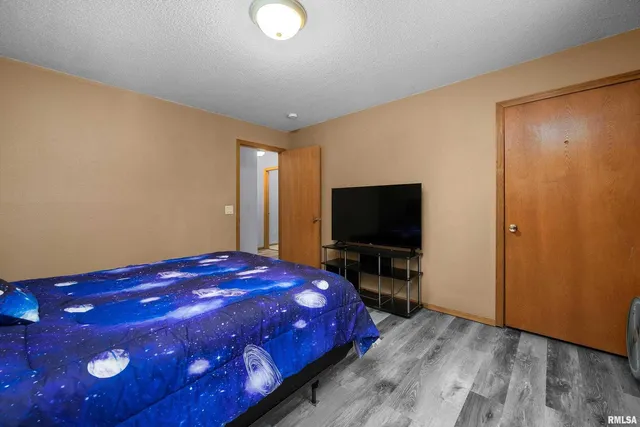 a bedroom with a bed and a chandelier