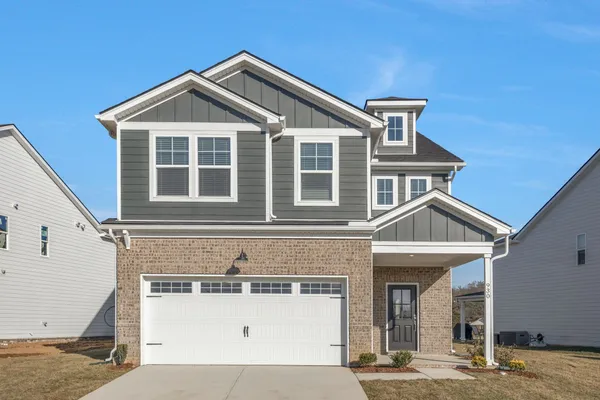 a front view of a house with a garage