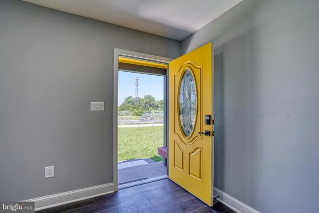 a kitchen with stainless steel appliances granite countertop wooden cabinets a stove a sink and dishwasher with wooden floor