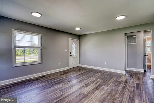a kitchen with granite countertop stainless steel appliances white cabinets and a sink