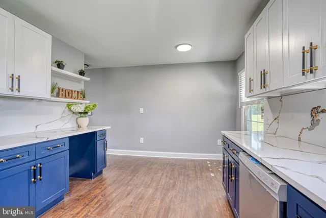a bathroom with a granite countertop sink toilet and mirror