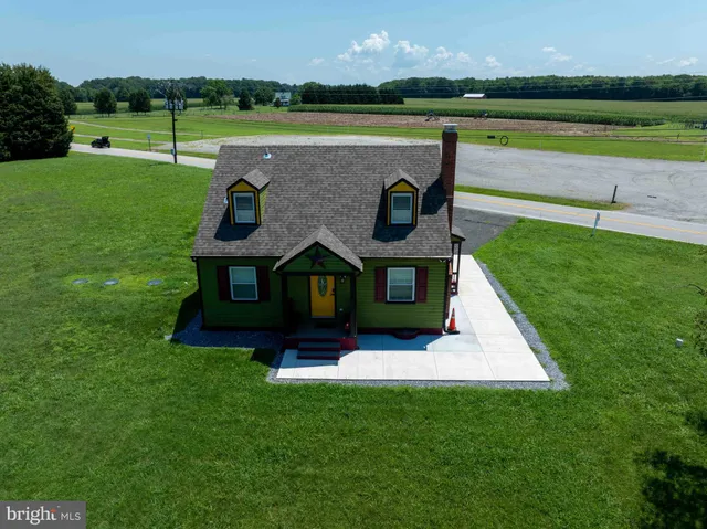 a view of a livingroom with wooden floor and window