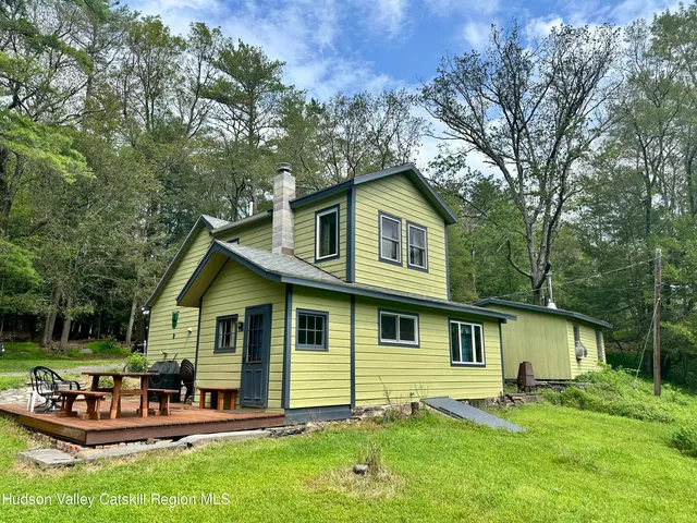 a view of a house with a yard porch and sitting area