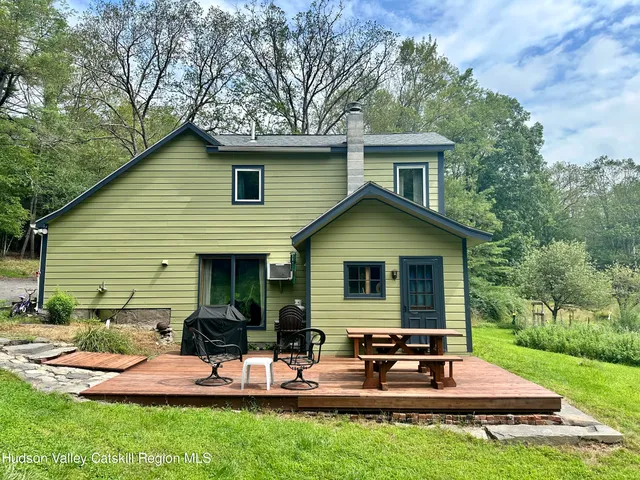 a view of a house with backyard sitting area and garden