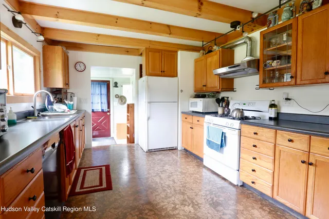 a kitchen with stainless steel appliances kitchen island granite countertop a sink and cabinets