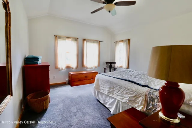 a bedroom with furniture and a large window
