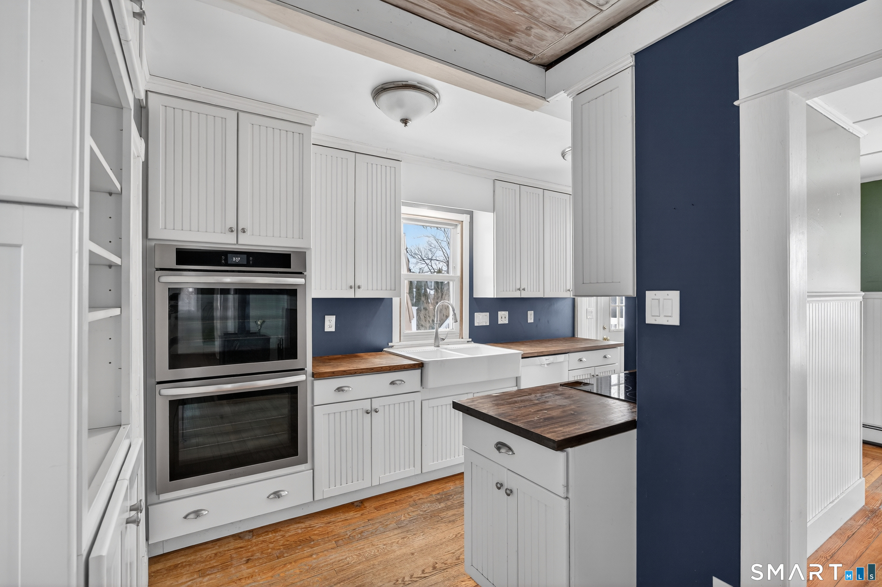 85 Baker Avenue Groton, CT 06340 - Photo 18 of 36 Beautiful white kitchen cabinets with stainless steel appliances and hardwood floors