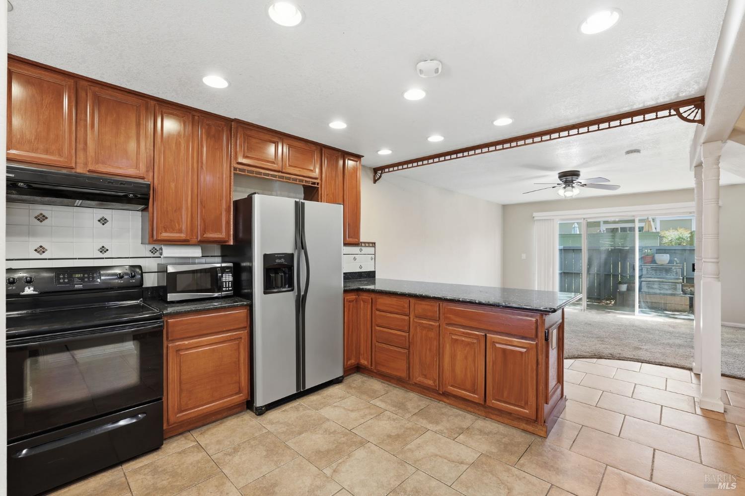 900 Southampton Road, Unit 169 Benicia, CA 94510 - Photo 4 of 21 a kitchen with stainless steel appliances granite countertop a refrigerator and a stove top oven