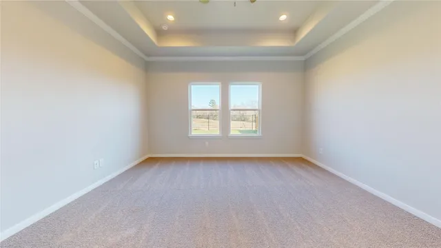 an empty room with windows and cabinet