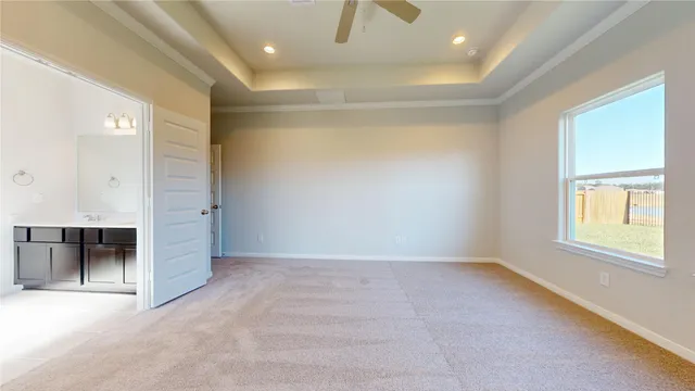 a view of a livingroom with wooden floor and a ceiling fan