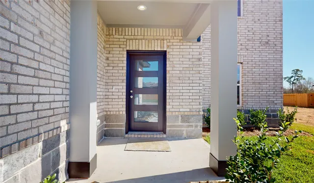 a view of entryway and gallery with wooden floor