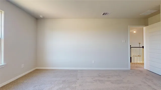 an empty room with closet and windows
