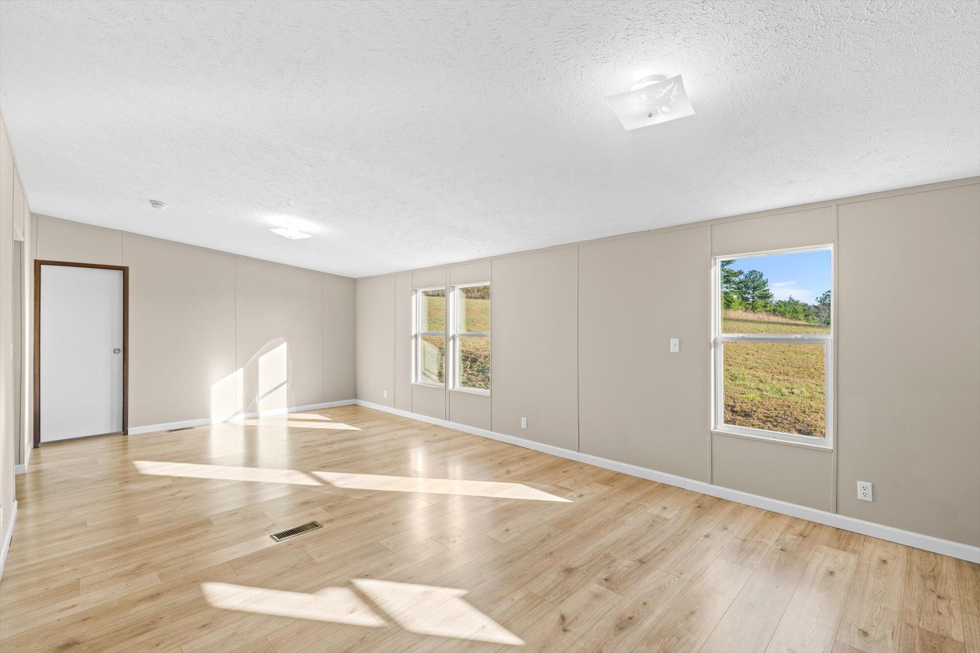 1202 Green Pond Road Decatur, TN 37322 - Photo 13 of 28 a view of empty room with wooden floor and fan