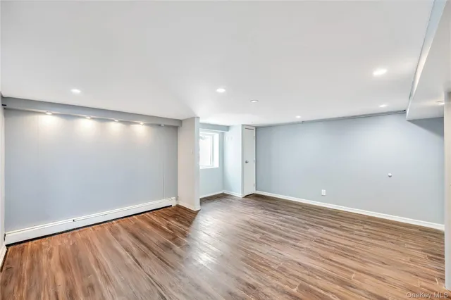 a view of an empty room with wooden floor