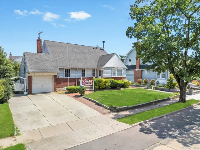 a front view of house with yard and green space