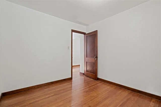 a view of an empty room and wooden floor