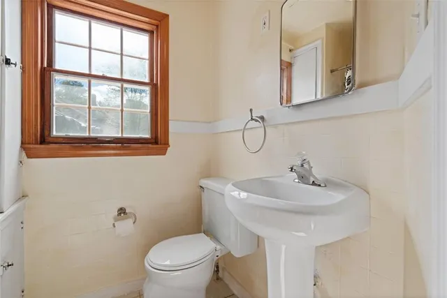 a bathroom with a sink toilet and mirror