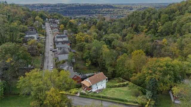 an aerial view of a house with a yard