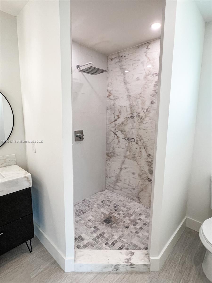 Collier City Pompano Beach, FL 33069 - Photo 11 of 28 a bathroom with a granite countertop shower a toilet and a sink