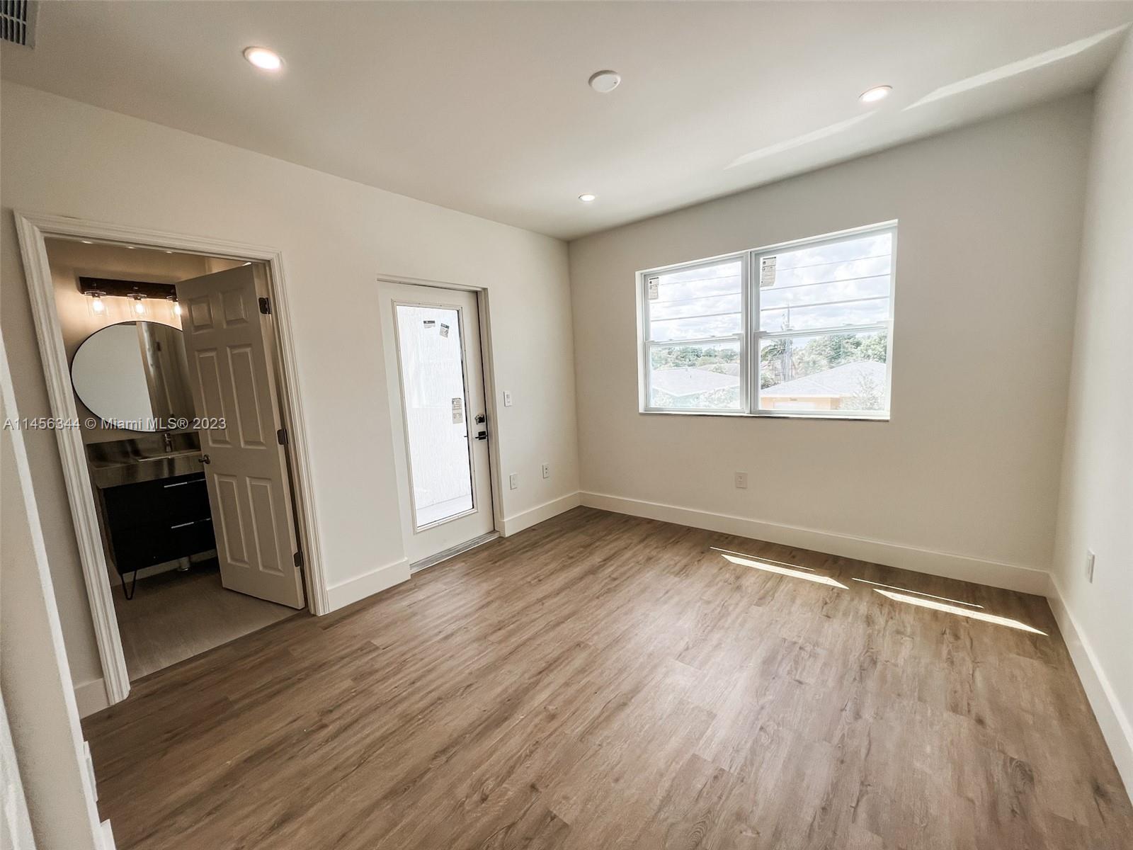 Collier City Pompano Beach, FL 33069 - Photo 16 of 28 an empty room with wooden floor and a window