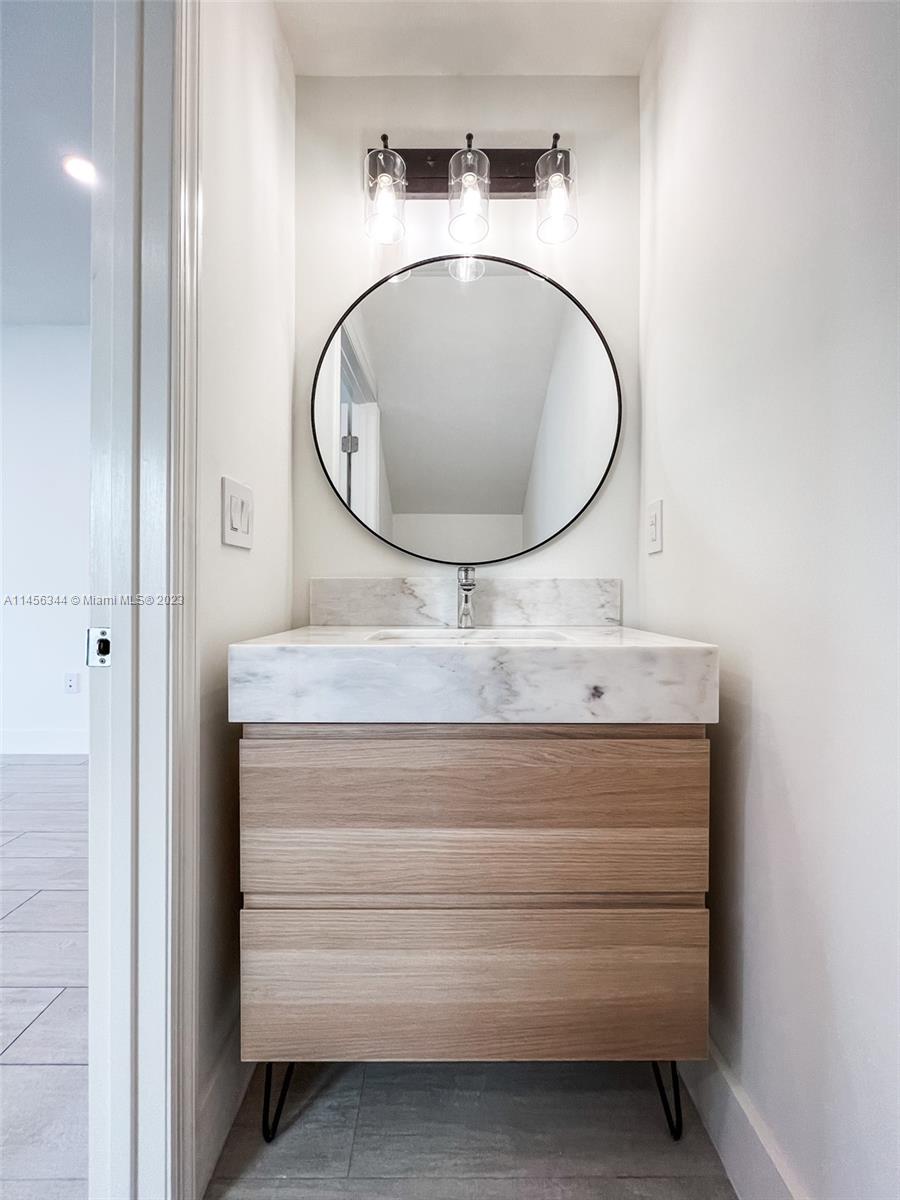 Collier City Pompano Beach, FL 33069 - Photo 22 of 28 a bathroom with a sink and a mirror