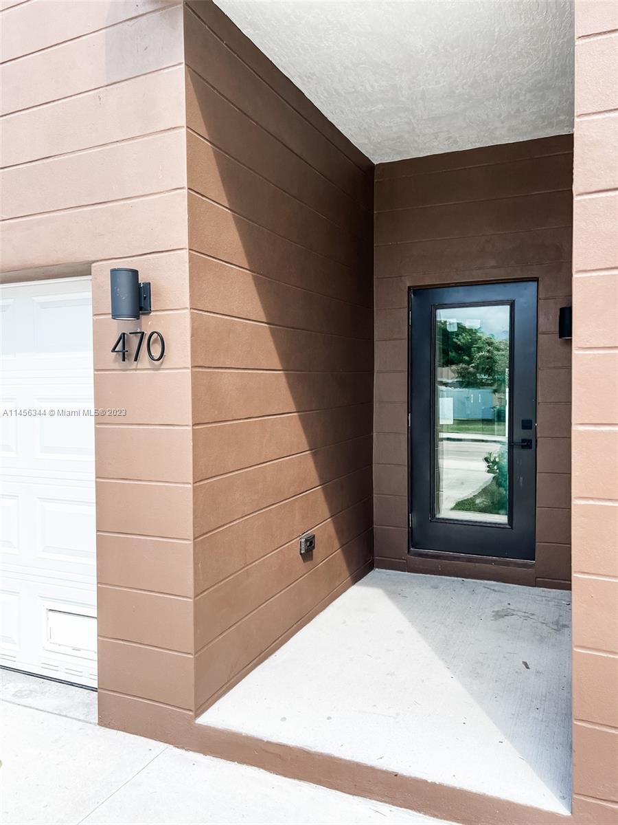 Collier City Pompano Beach, FL 33069 - Photo 3 of 28 a view of a front door of the house
