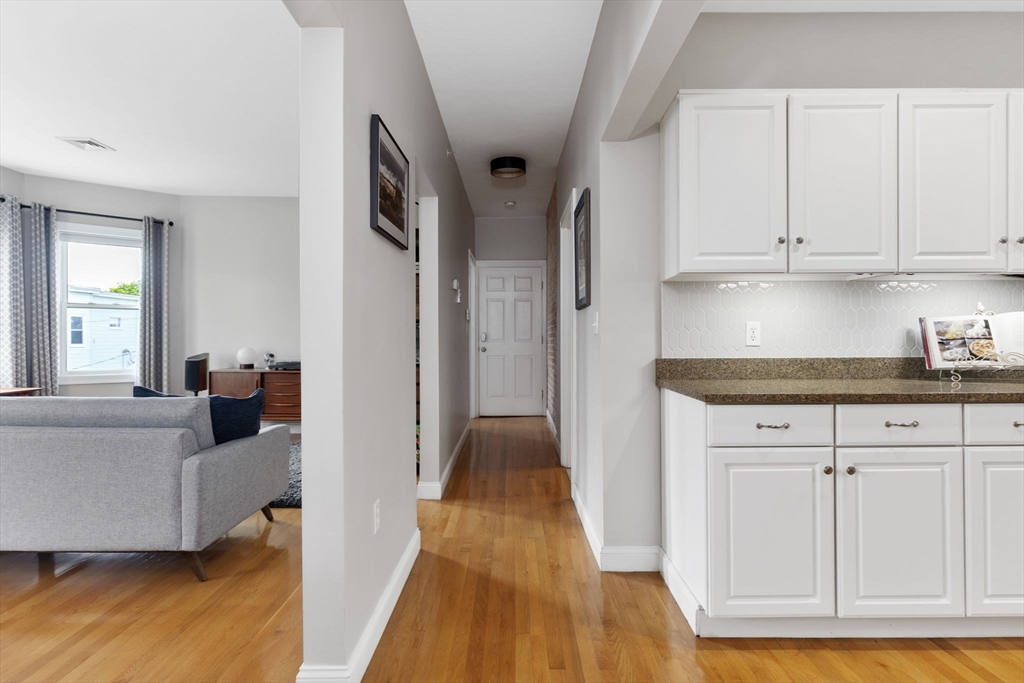 51 Dimick Street, Unit 5 Somerville, MA 02143 - Photo 12 of 28 a view of a livingroom with wooden floor and cabinet