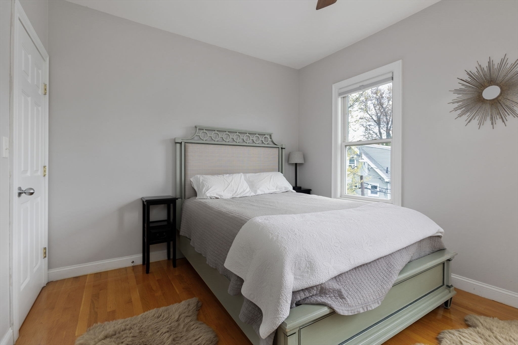 51 Dimick Street, Unit 5 Somerville, MA 02143 - Photo 17 of 28 a bedroom with a bed and a window