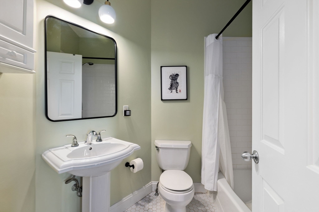 51 Dimick Street, Unit 5 Somerville, MA 02143 - Photo 18 of 28 a bathroom with a toilet sink and mirror