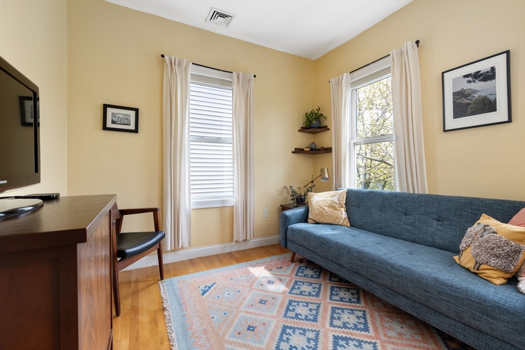 51 Dimick Street, Unit 5 Somerville, MA 02143 - Photo 19 of 28 a living room with furniture and a window