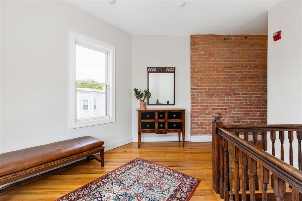 51 Dimick Street, Unit 5 Somerville, MA 02143 - Photo 10 of 28 a living room with furniture and a rug