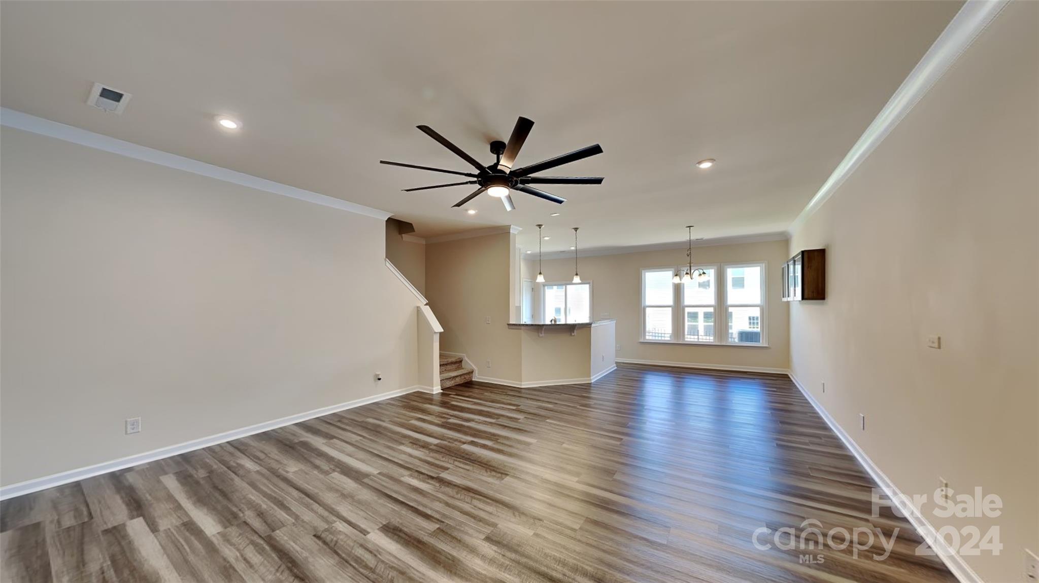 814 Canoe Song Road Fort Mill, SC 29708 - Photo 3 of 20 an empty room with wooden floor fan and windows