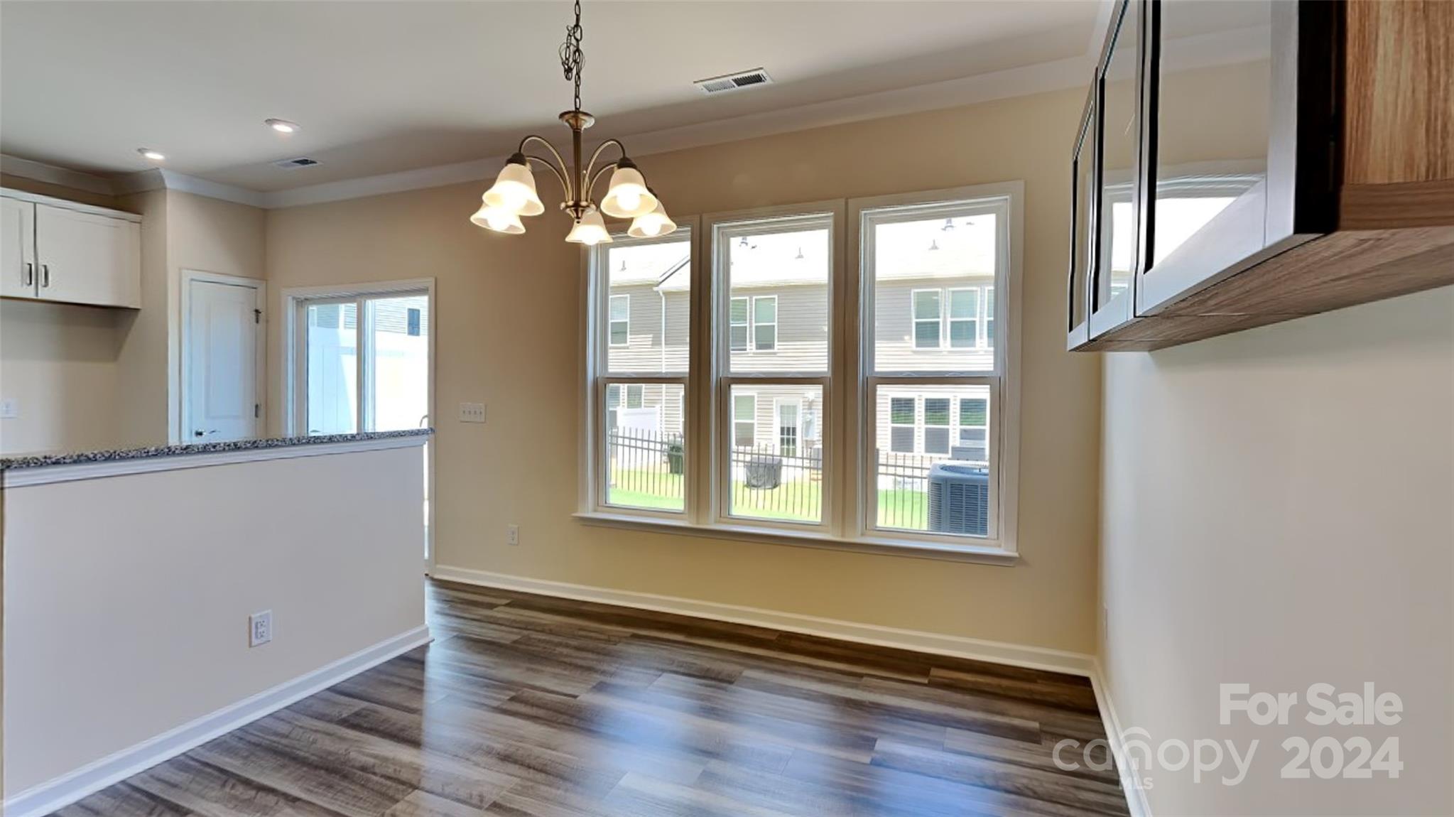 814 Canoe Song Road Fort Mill, SC 29708 - Photo 4 of 20 a view of an empty room with wooden floor and a window