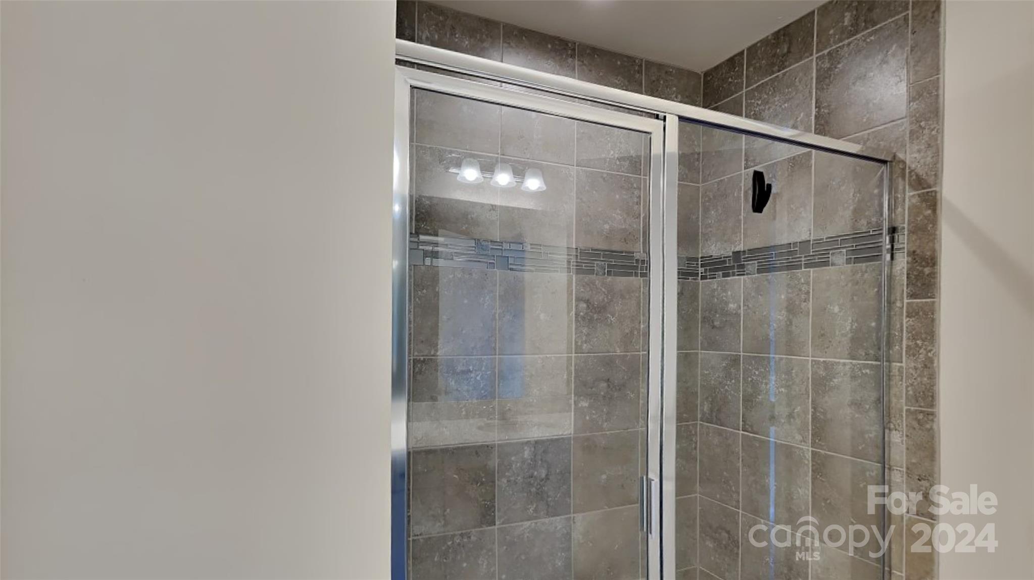 814 Canoe Song Road Fort Mill, SC 29708 - Photo 10 of 20 a bathroom with a glass shower door