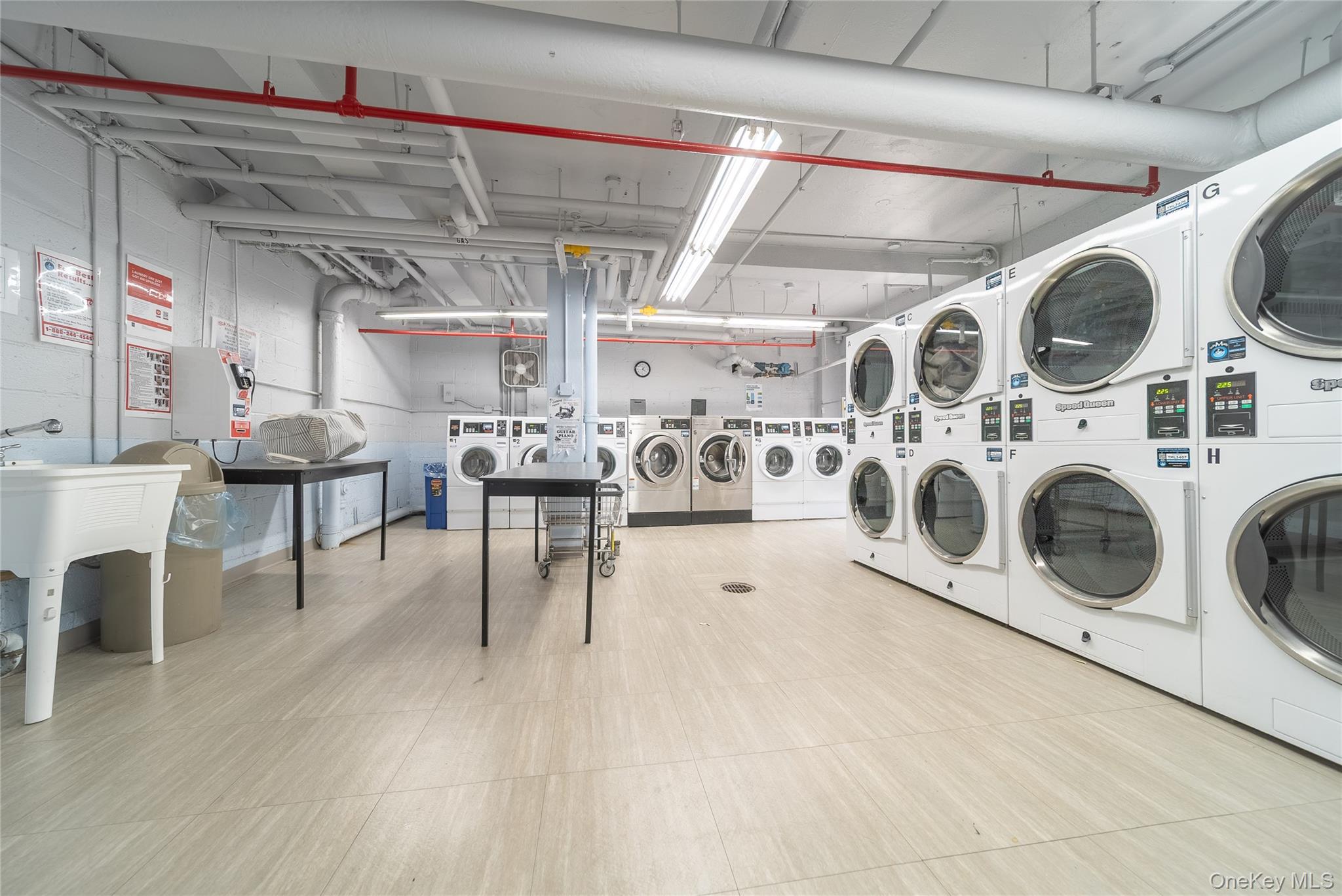 99-32 66th Road, Unit 9N Queens, NY 11374 - Photo 12 of 16 a view of a kitchen with stainless steel appliances granite countertop a stove a table and chairs