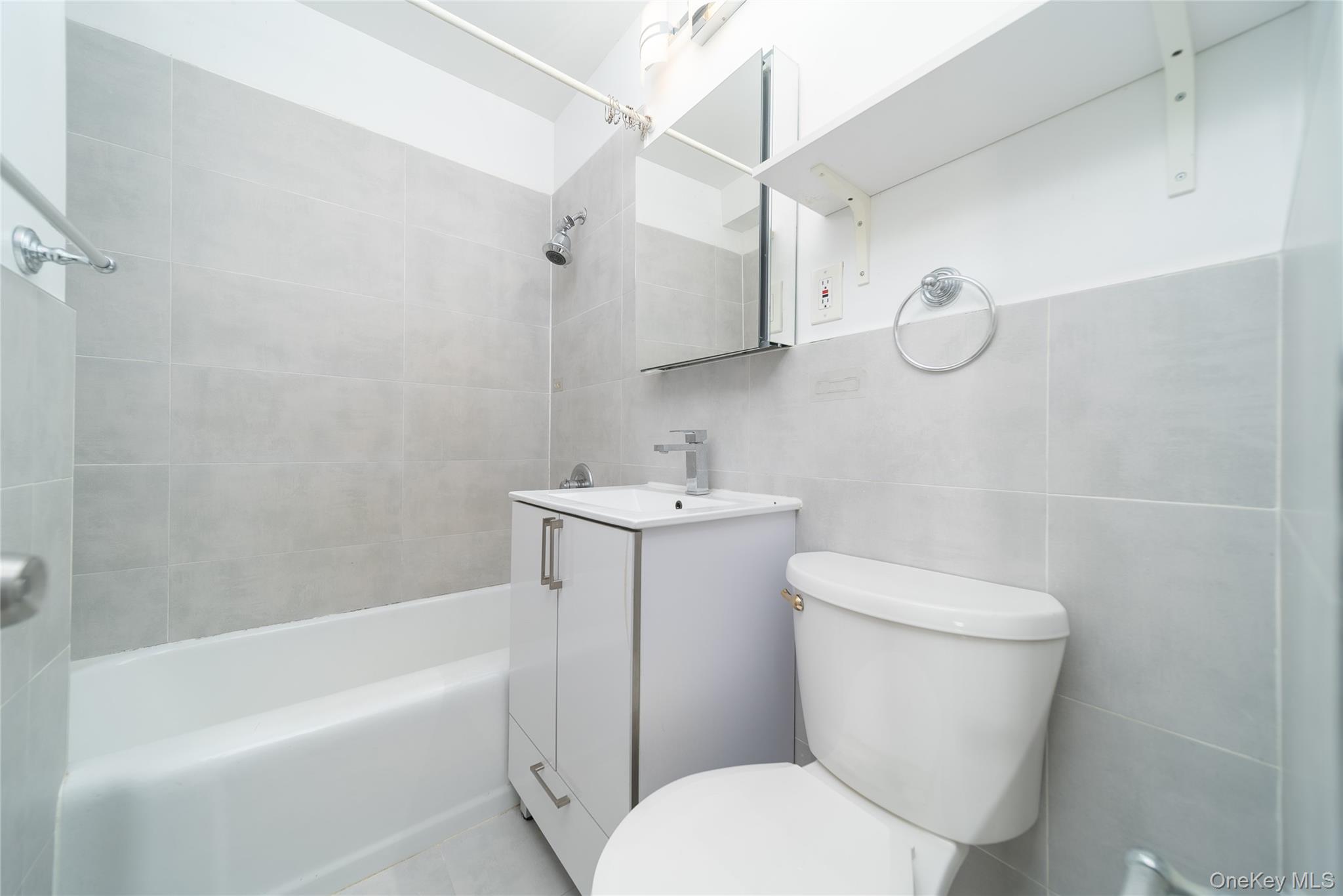 99-32 66th Road, Unit 9N Queens, NY 11374 - Photo 13 of 16 a white toilet sitting next to a bath tub