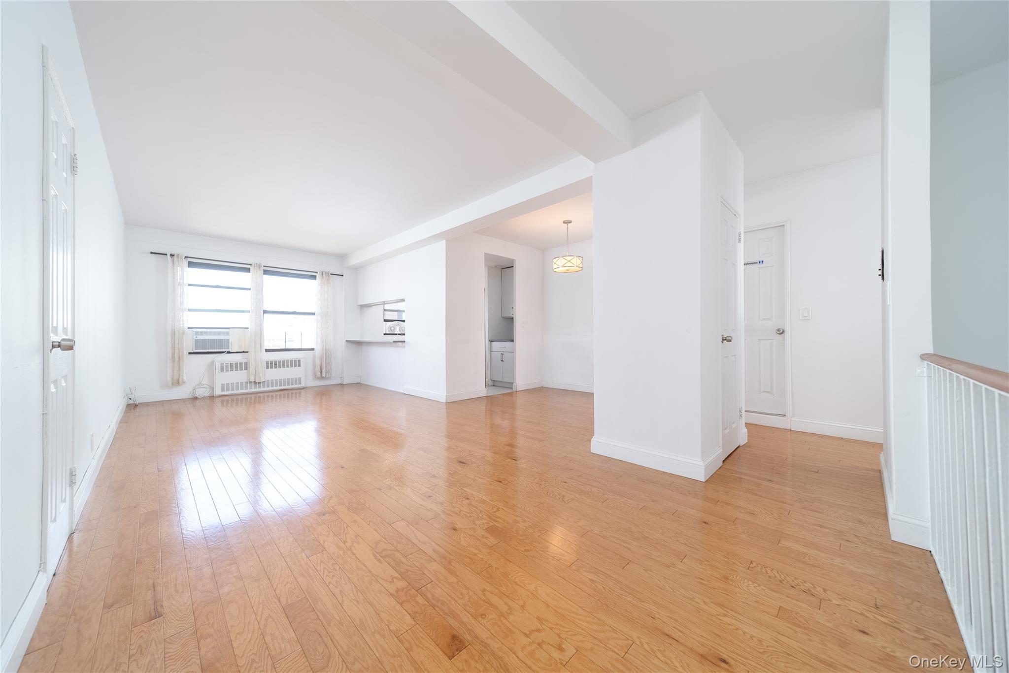 99-32 66th Road, Unit 9N Queens, NY 11374 - Photo 6 of 16 wooden floor in an empty room with a window