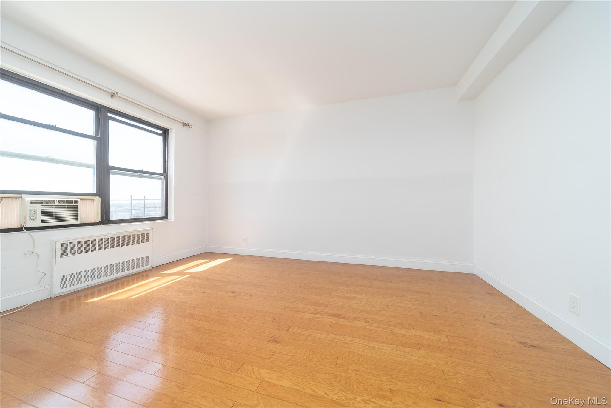 99-32 66th Road, Unit 9N Queens, NY 11374 - Photo 7 of 16 an empty room with a window