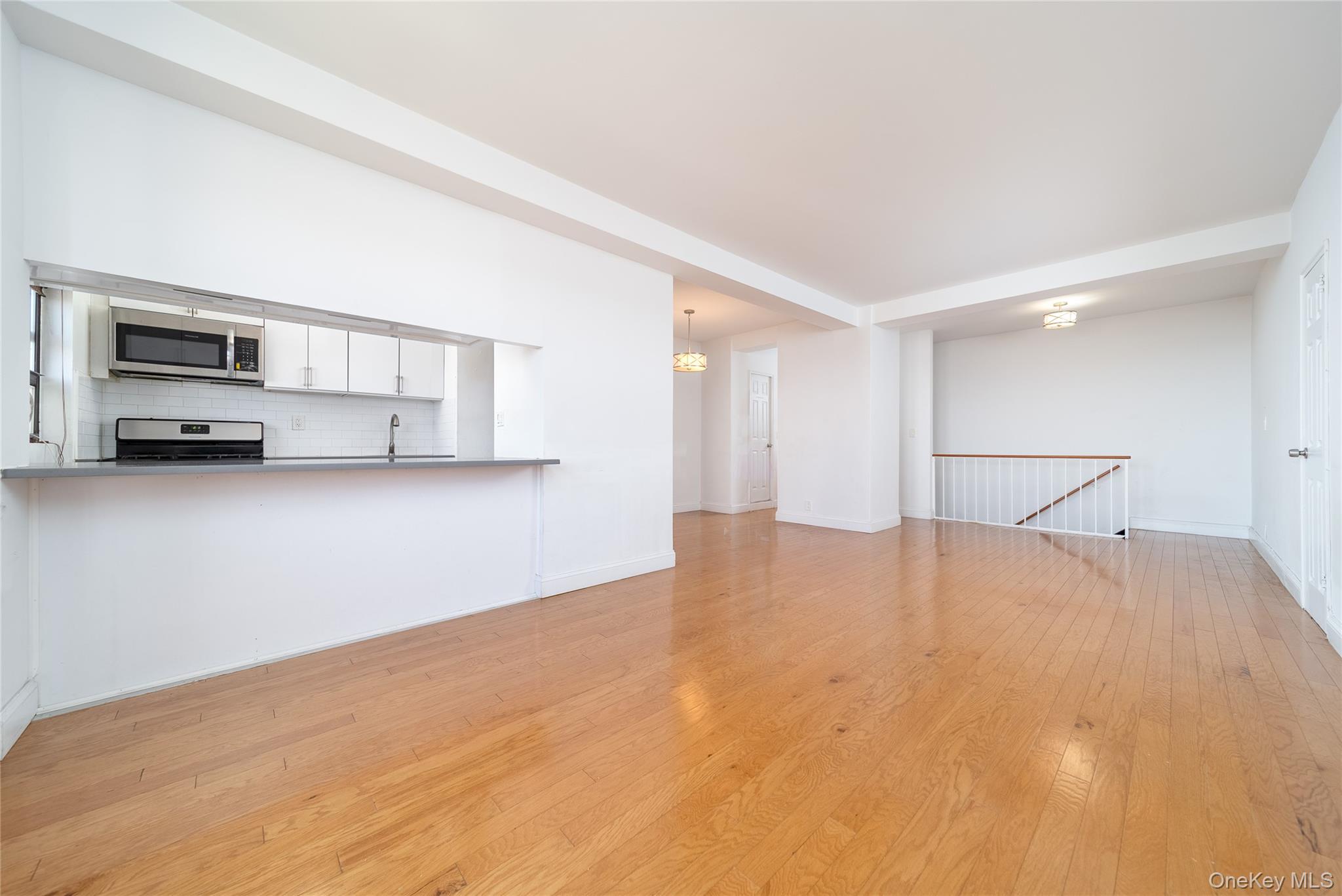 99-32 66th Road, Unit 9N Queens, NY 11374 - Photo 8 of 16 a view of empty room with a kitchen
